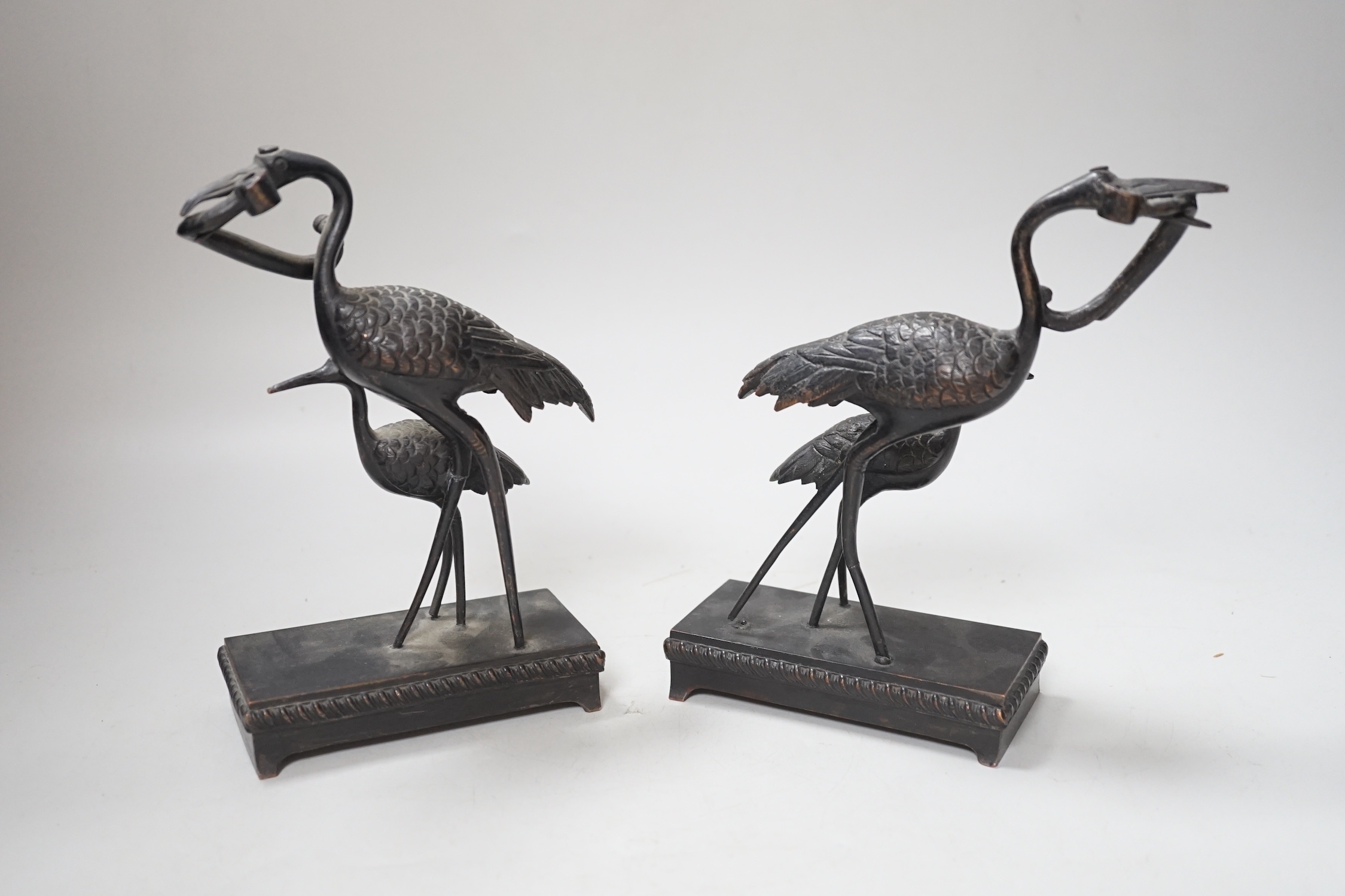 A pair of Japanese bronze crane figure groups, on later bases, 18cm high